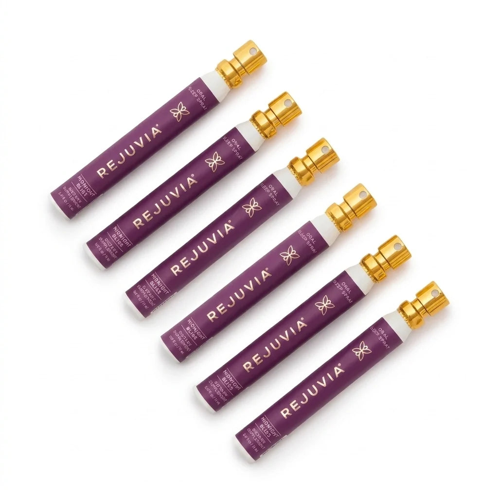 Six Rejuvia Oral Sleep sprays atomizers arranged diagonally on a clean white background. The spray canisters feature a deep purple label with gold lettering and a metallic gold spray nozzle.